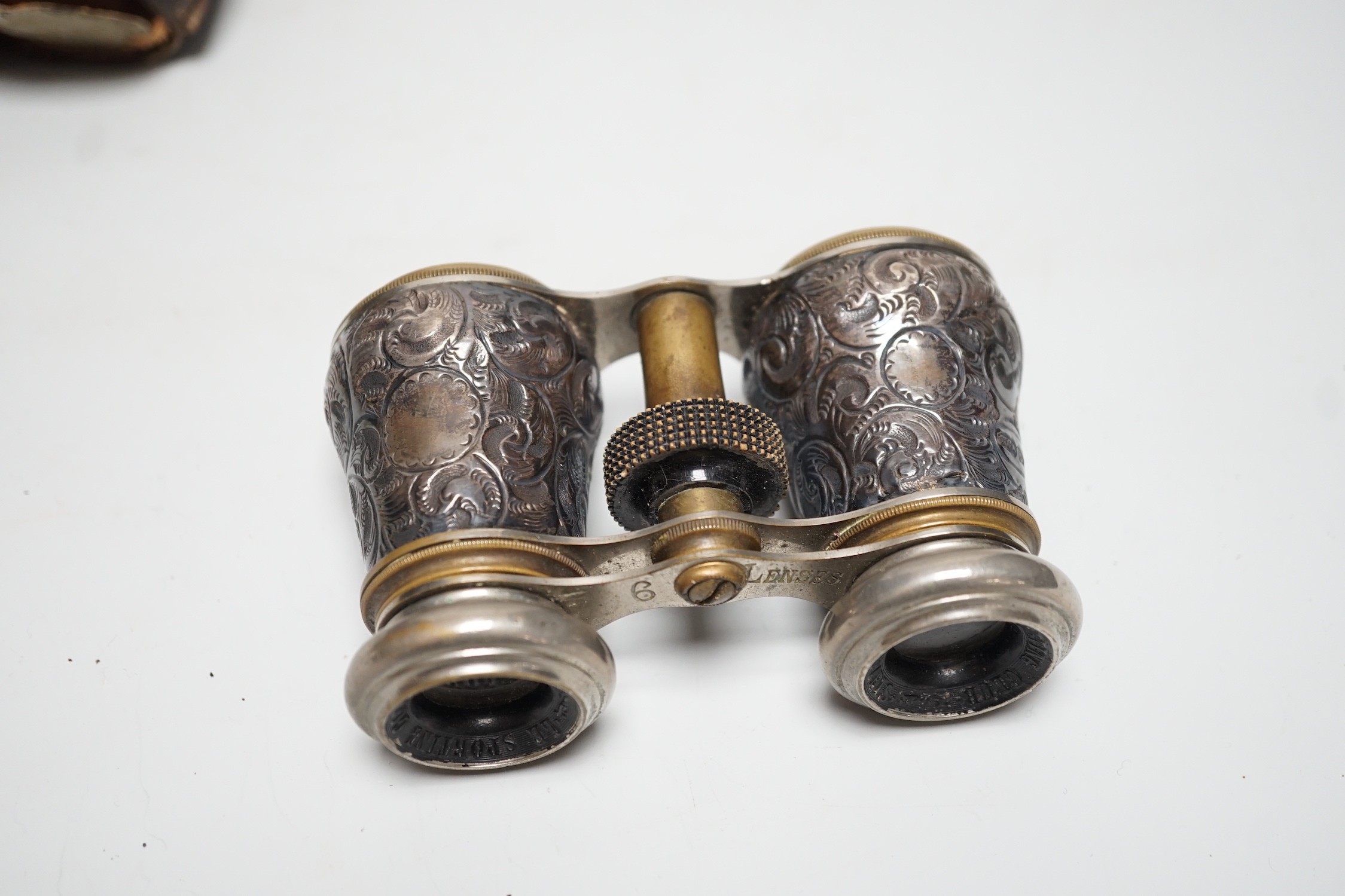 A pair of late Victorian repousse silver mounted brass opera glasses, Birmingham, 1900, (cased)